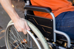 Suggesting future healing, someone moves forward in a wheelchair.